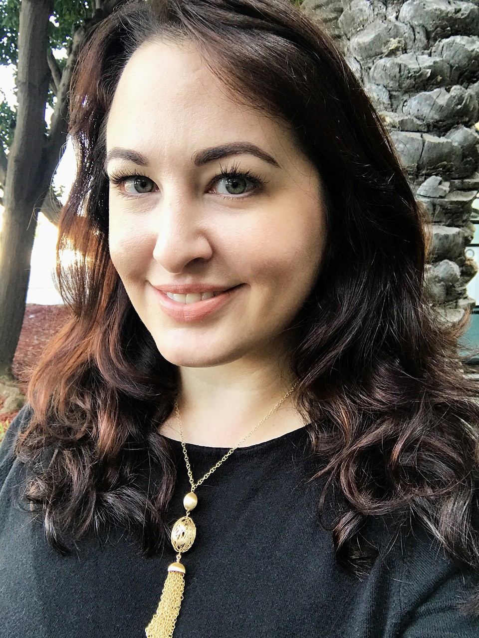 How to dress for a vlogger conference - black wrap dress and Ben Bridge gold tassel necklace